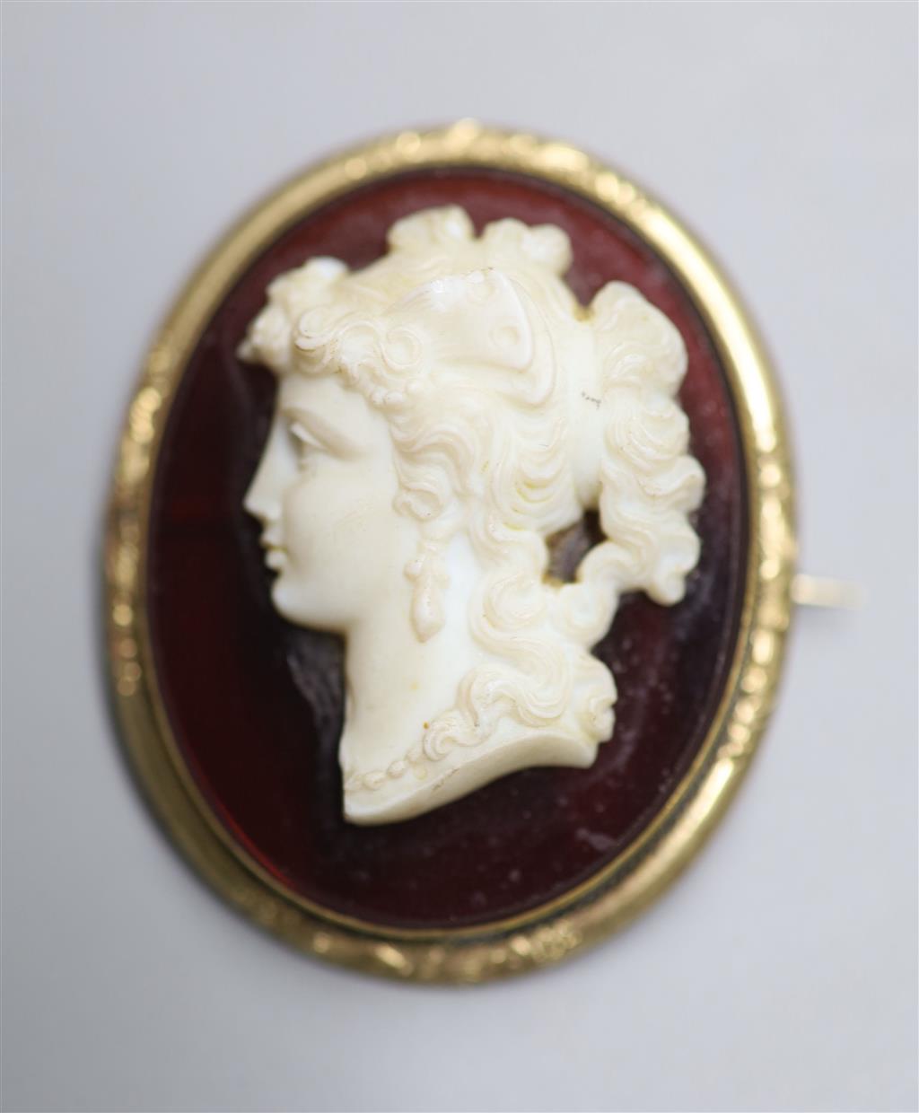 A Victorian gilt metal mounted composition glass? oval cameo brooch, carved with bust of a lady to dexter, 45mm.